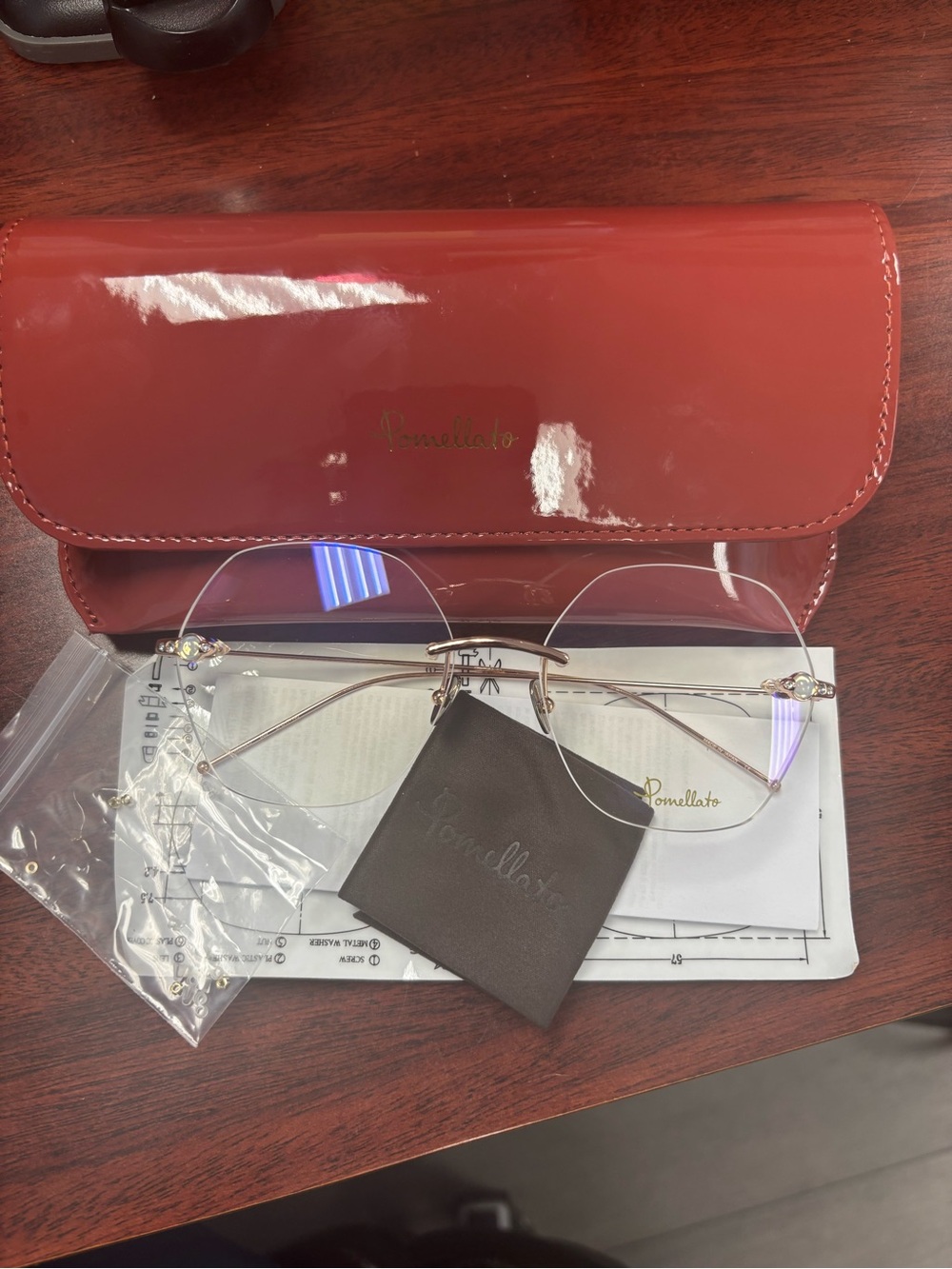 Pomellato Gold Rimless Glasses with Red Case
